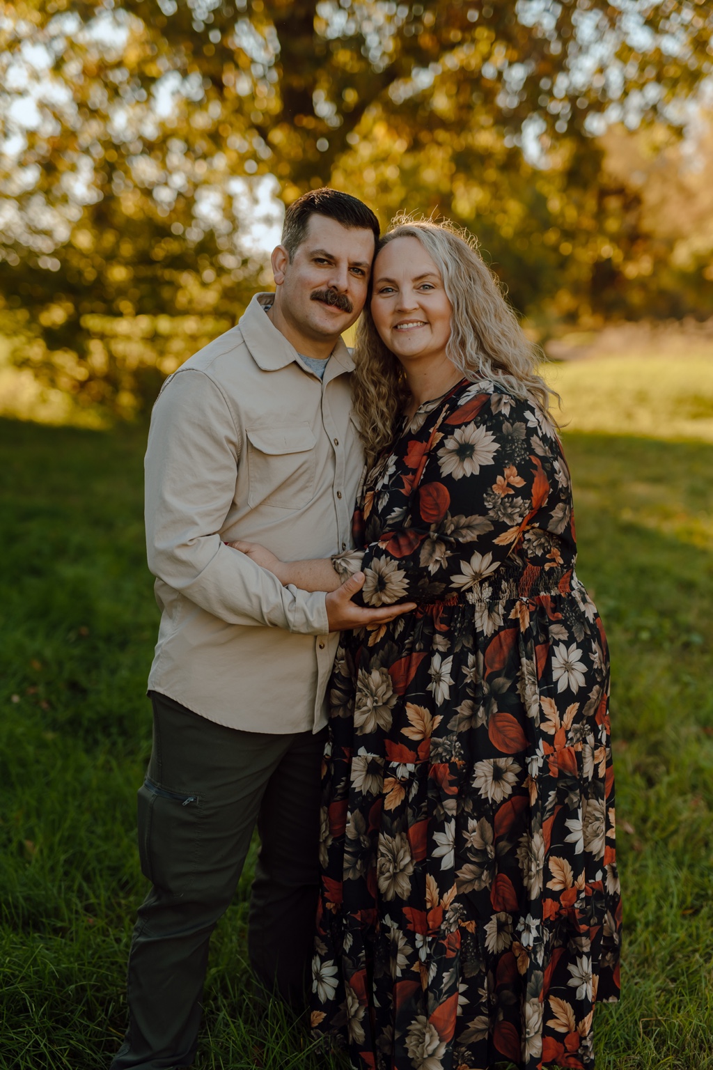 Damian Hansen and his wife Pearle posing together outdoors in autumn light.