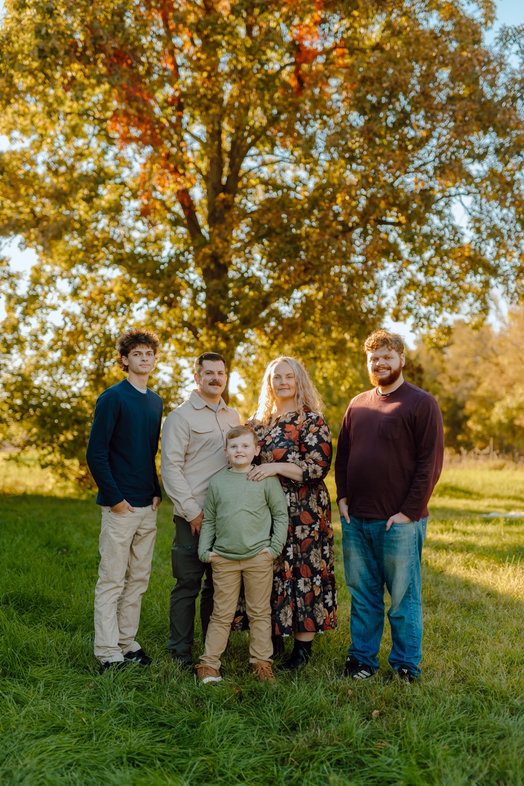 The Hansen family standing together outdoors in a field.